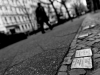 A close shot of a name plate embedded in the street