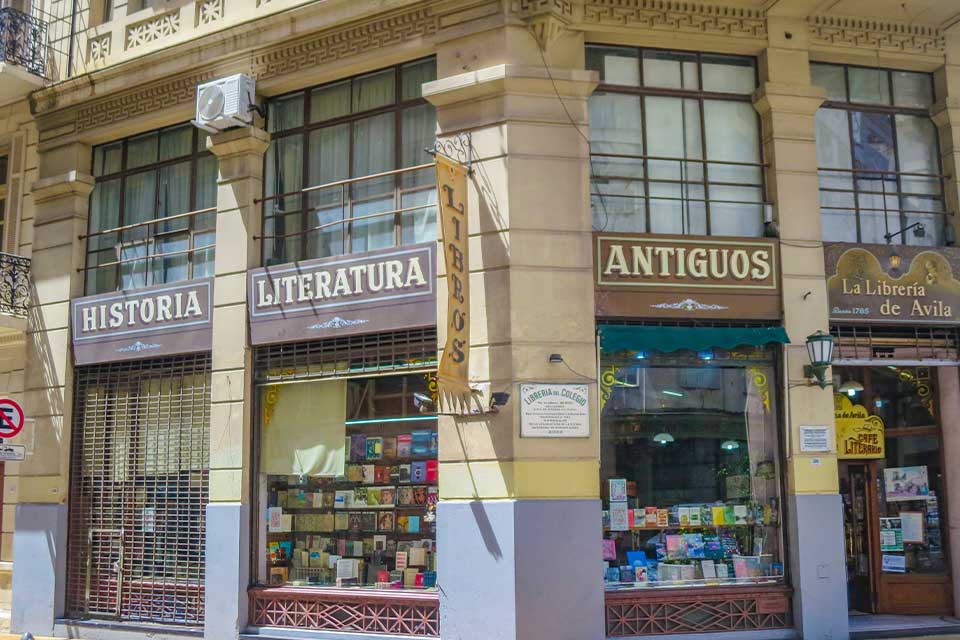 A photograph of a building occupying the corner of a busy city street