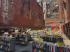 Racks of books on sale outdoors in a city alleyway