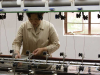 A woman stands on the production line of an industrial garment factory