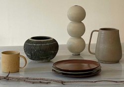 A photograph of five ceramic pieces staged on a table