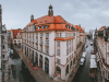 A panaroma shot of Leipzig with a large building protruding in the foreground