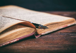 A photograph of an old book on a wooden desk