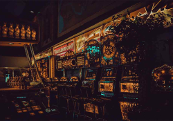 A photograph of a wall of slot machines, rendered through a surreal reverse image filter