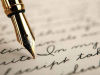 A photograph of a fountain pen writing in cursive on paper