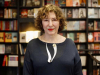 A photograph of Azar Nafisi posing in front of a book shelf