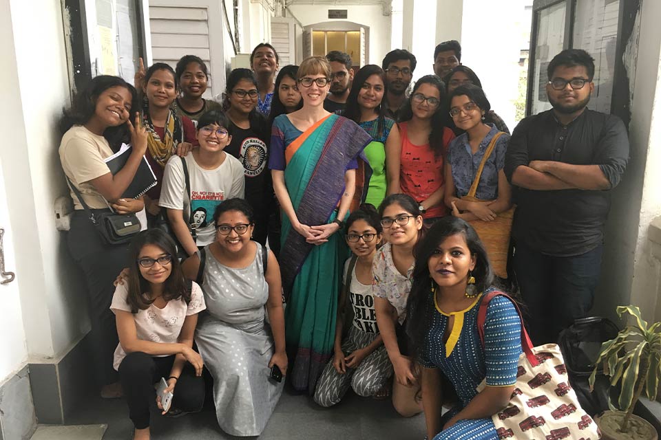 A photograph of a group of Indian students with their teacher