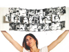 A woman holds up a book filled with illustrations above her head