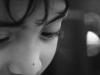 A black and white photograph close-up of a child's face