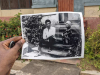 A photograph of a person holding a photograph of Wolé Soyinka